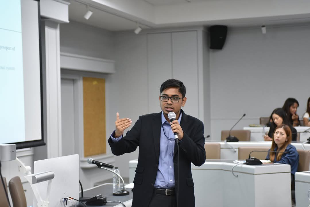 Rubiat Saimum giving a presentation with a handheld microphone